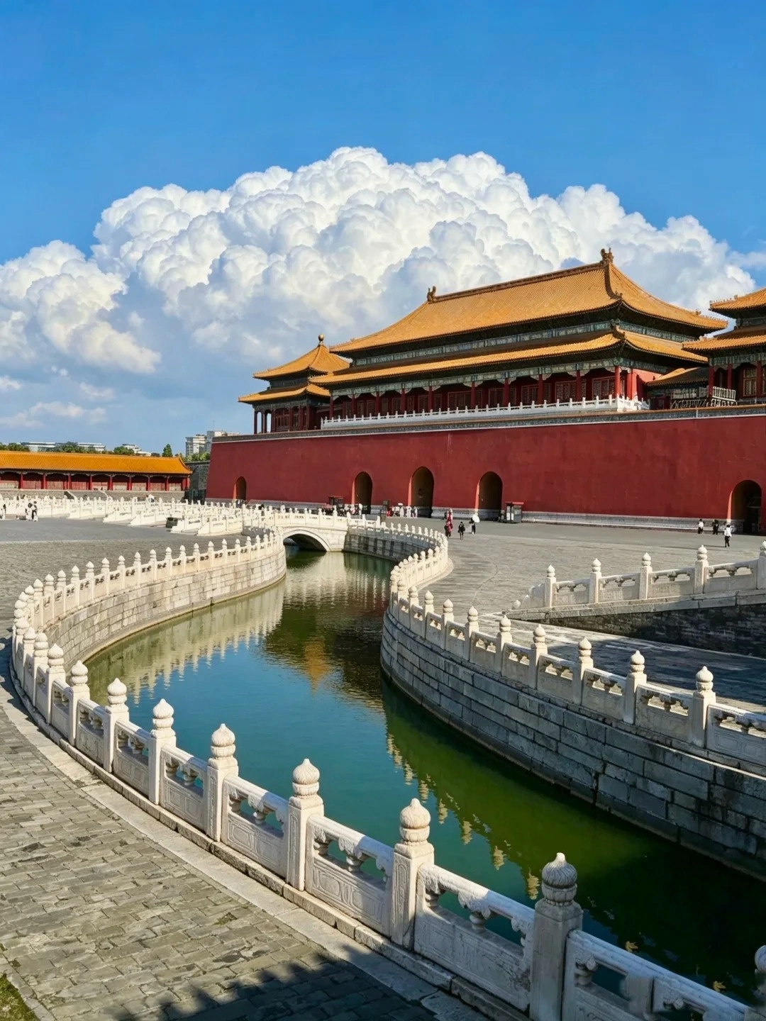 A view of the Forbidden City's red palace walls and yellow-tiled roofs, with a curved moat in the foreground lined by white stone balustrades.